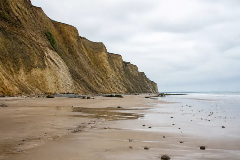 Plage de sable au pied des falaises argileuses à Houlgate lors d'une marée basse