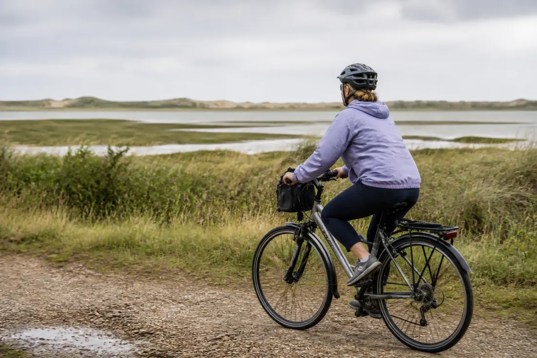 Un cycliste sur un circuit nature Sallenelles Cabourg traverse les sentiers de l'estuaire